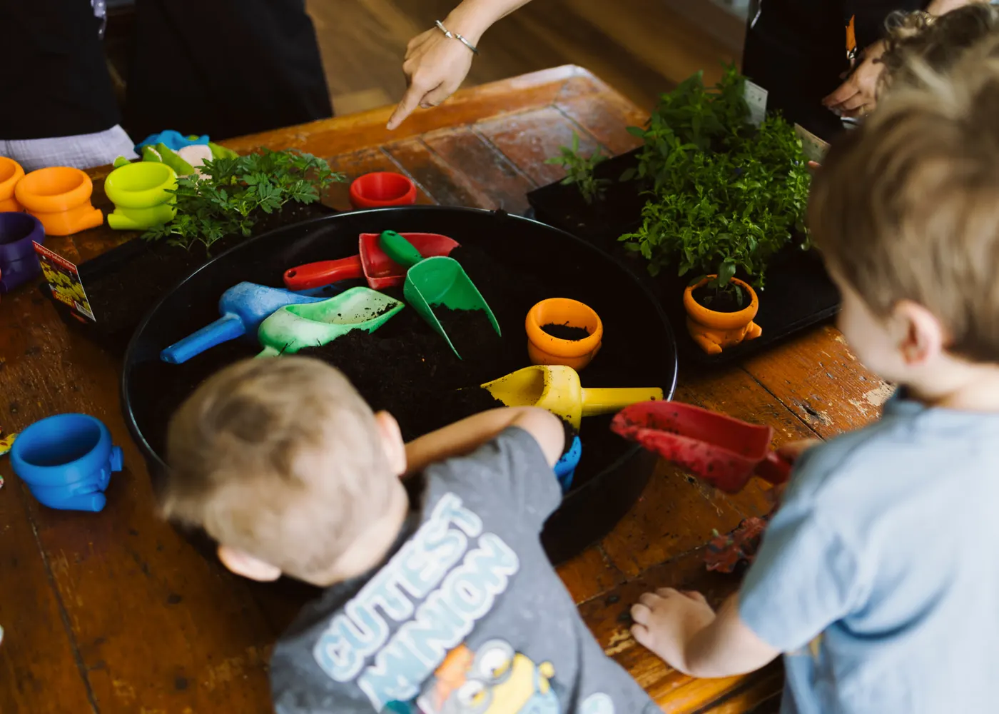 Children working side by side at a gardening table